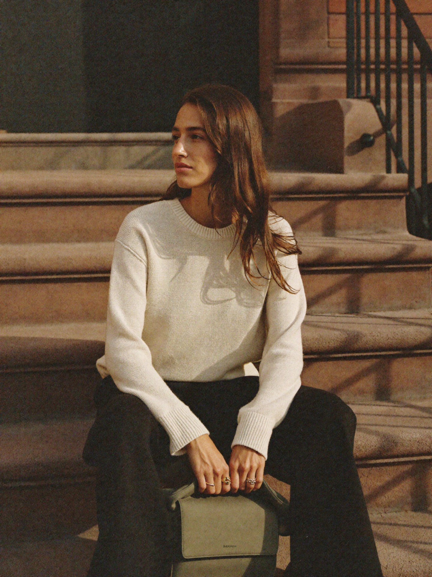 Coco sitting NYC brownstone steps with Bowryn Slouch Olive - lookbook editorial