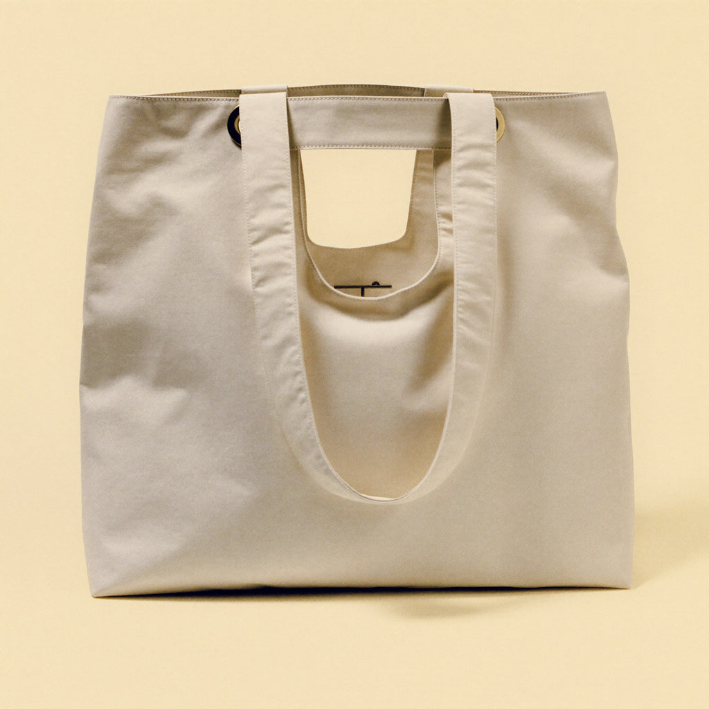 The Tote front view — premium cream nylon Bowryn handbag