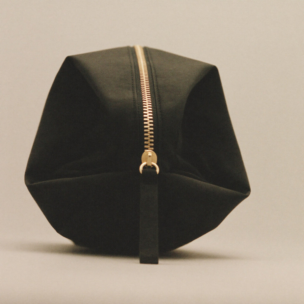 The Pouch 3/4 angle showing depth and brass zipper detail