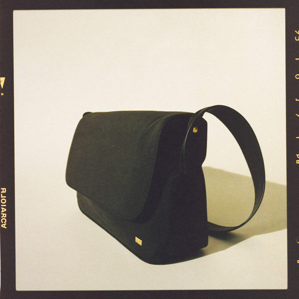 The Shoulder Bag 3/4 angle showing soft drape and brass hardware
