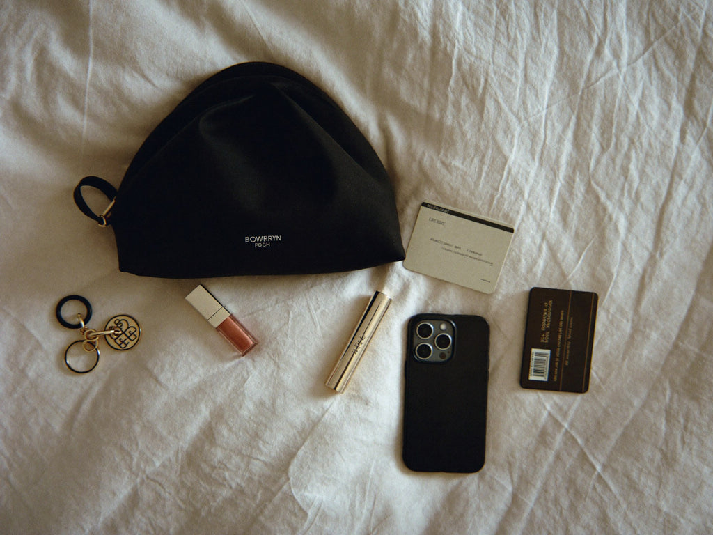 The Pouch evening flat lay with lipstick, iPhone, keys, credit cards
