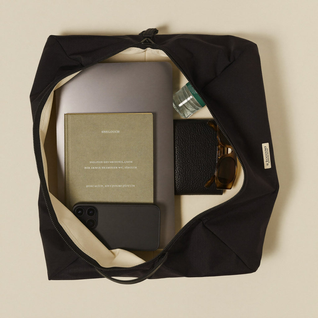 The Slouch open showing organized spacious interior with laptop, book and essentials