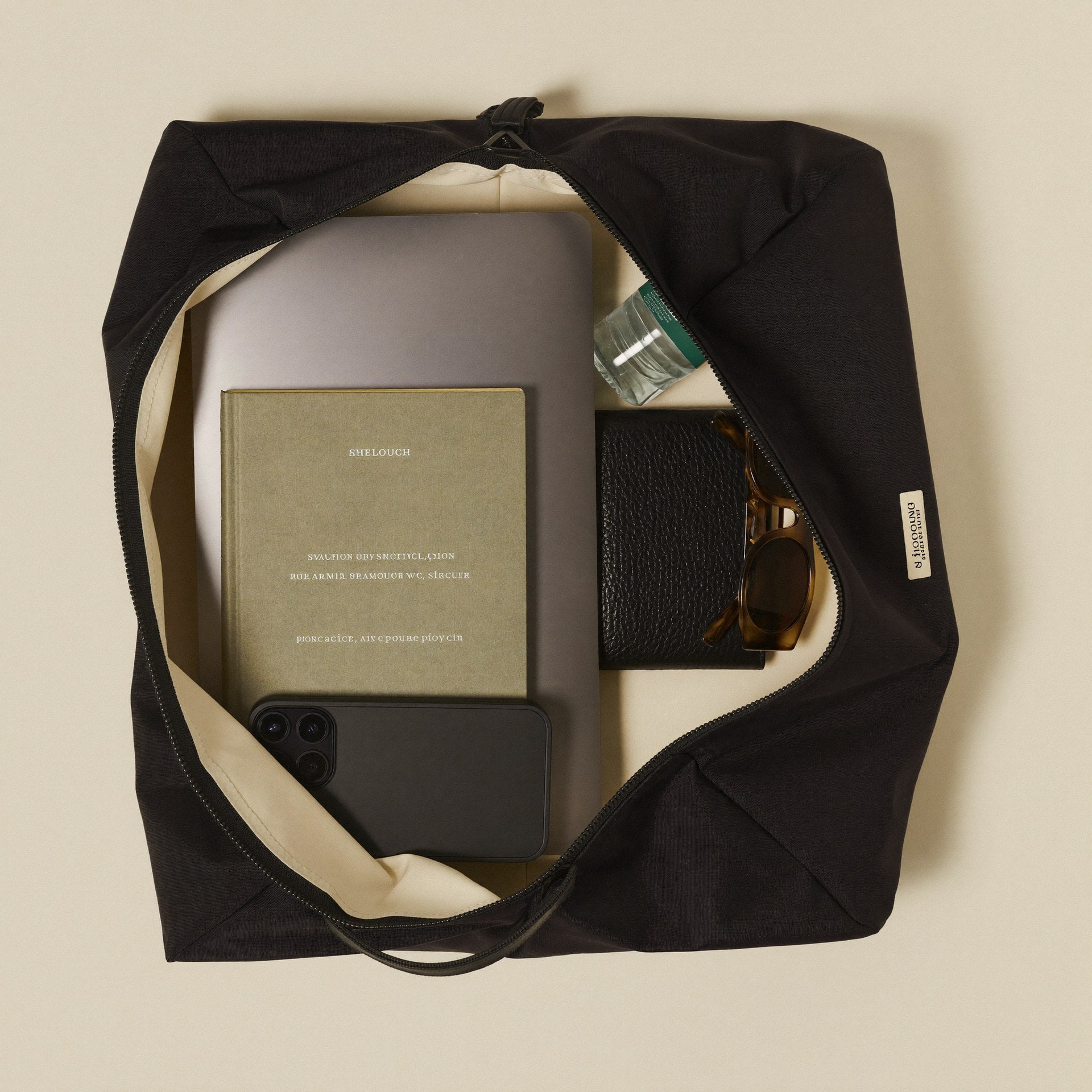The Slouch open showing organized spacious interior with laptop, book and essentials
