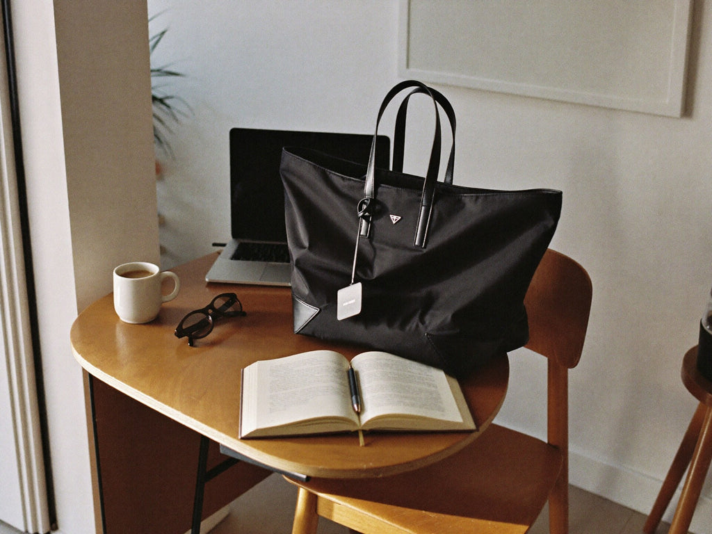 The Tote in black on chair in minimalist Miami home office workspace