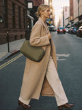 Woman walking NYC fall golden hour with The Shoulder Bag in Olive premium nylon by Bowryn — warm beige editorial