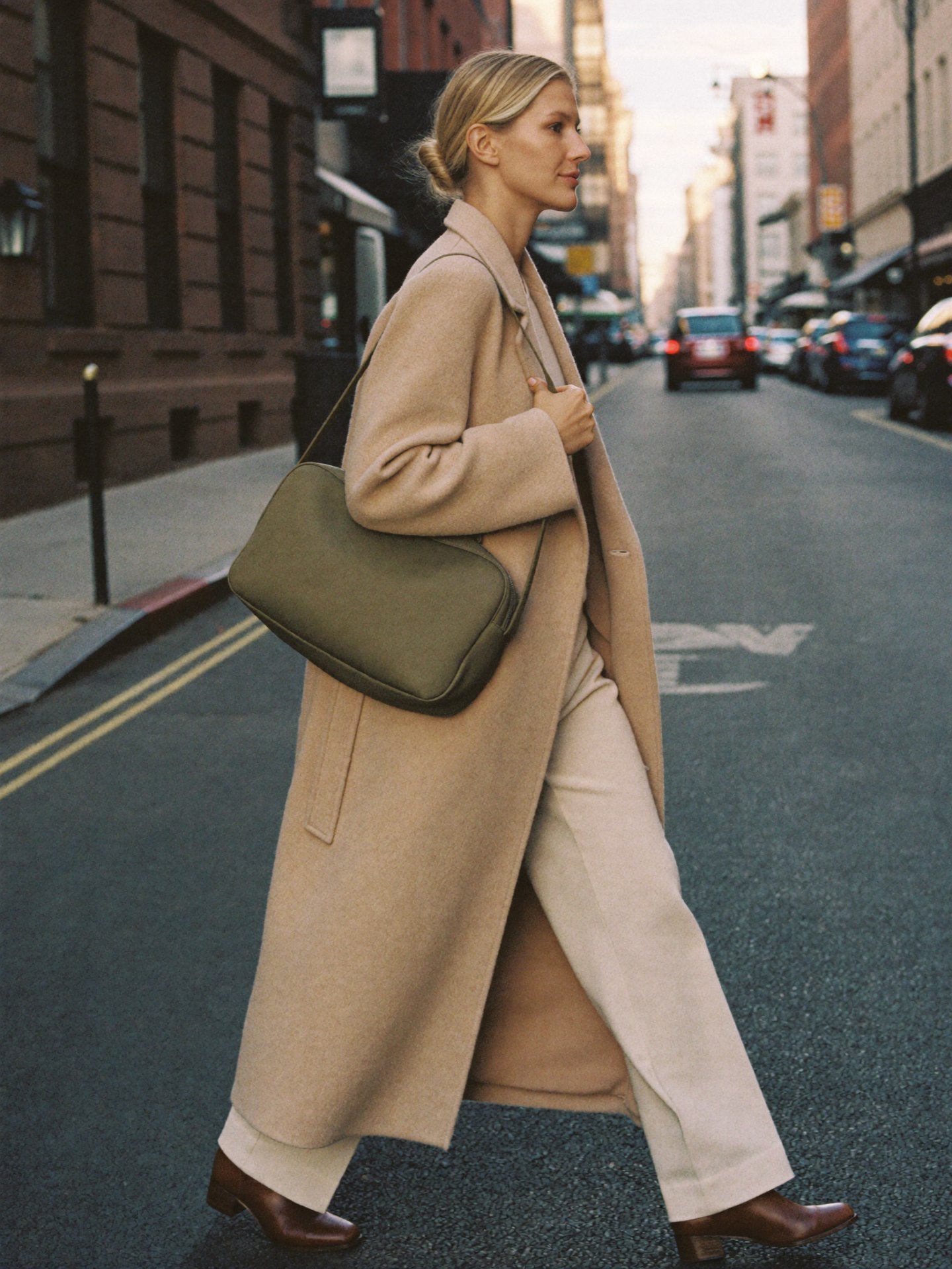 Woman walking NYC fall golden hour with The Shoulder Bag in Olive premium nylon by Bowryn — warm beige editorial
